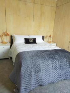 a bedroom with a large bed and two night stands at Relax in Kenmure in Dunedin
