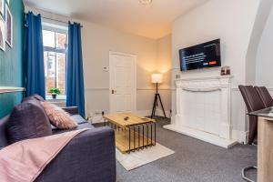 a living room with a couch and a fireplace at Luke Stays - Saint Aidans Street in Gateshead