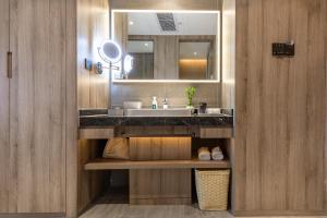 a bathroom with a sink and a mirror at Atour Changsha Xingsha in Changsha +23 photos