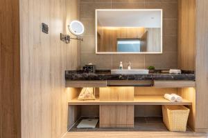 濰坊的住宿－潍坊火车站青年路亚朵酒店，一间带水槽和镜子的浴室