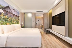TV a/nebo společenská místnost v ubytování Atour Hotel Dalian Zhuanghe