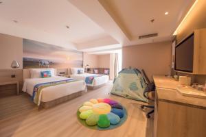 a hotel room with two beds and a baby crib at Atour Hotel Hohhot Drum Tower Manduhai in Hohhot