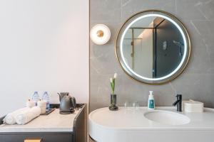 a bathroom with a sink and a mirror at Atour X Hotel Renmin Bridge South Metro Panmen Scenic Area Suzhou in Suzhou +56 photos
