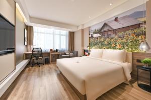 TV a/nebo společenská místnost v ubytování Atour Hotel Dalian Zhuanghe