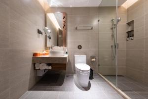 a bathroom with a toilet and a sink and a shower at Atour Hotel X Nanshan Coastal City Shenzhen in Shenzhen +25 photos