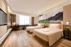 TV a/nebo společenská místnost v ubytování Atour Hotel Dalian Zhuanghe