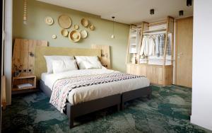 a bedroom with a large bed and a window at Auberge d'Aillon et d'Ailleurs in Aillon-le-Jeune