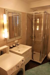 a bathroom with a shower and a sink and a toilet at Appartement Eveline in Velden am Wörthersee