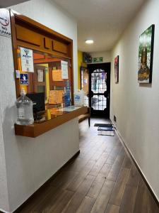 a fast food restaurant with a counter and a hallway at Hotel Casa Frida in Cuernavaca