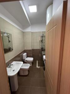 a bathroom with two toilets and a sink at Miloen Residence Gjiri I Lalzit in Durrës +53 photos