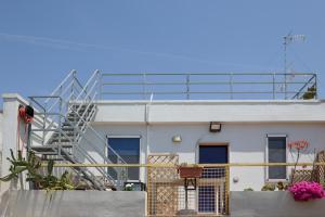 a building with a staircase on the side of it at Salento Sea & Sun Apartment in Porto Cesareo +28 photos
