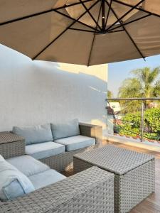a living room with a couch and an umbrella at Hotel Casa Frida in Cuernavaca