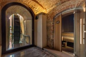 a large brick building with a large window at Hotel Mulino di Firenze - WorldHotels Crafted in Florence