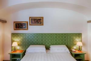 Łóżko lub łóżka w pokoju w obiekcie Hotel Mulino di Firenze - WorldHotels Crafted