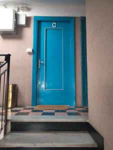 a blue door in a room with a tile floor at Casa di Clara in Rapallo