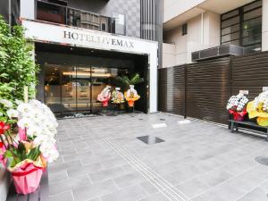 a store front of a hotel lobby with flowers in front at HOTEL LiVEMAX Sendai Aobadori in Sendai