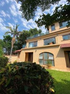 a house with a palm tree in front of it at Vintage Serene Villa in Hartbeespoort