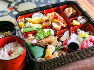 a lunch box filled with sushi and other foods at naokonoza Bettei Umekoji in Kyoto