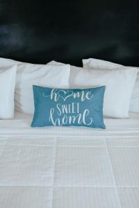 a bed with a pillow that says some smell normal at Sea Air Inn & Suites - Downtown - Restaurant Row in Morro Bay