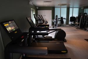 a gym with treadmills and ellipticals in a room at The Billesley Manor Hotel in Stratford-upon-Avon