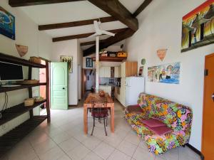 a living room with a couch and a table at Albis Harena - Ibiscus Attico Ocean View in Santa Maria