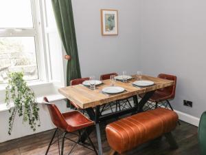 a dining room with a table and chairs at 40 Main Street in Burntisland