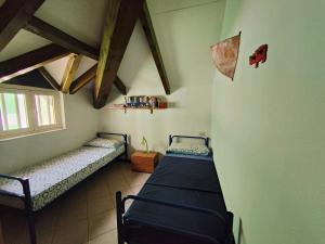 a room with two beds and a window at Albis Harena - Ibiscus Attico Ocean View in Santa Maria
