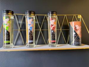 a shelf with four empty drink cups on it at La Suite Maléfik in Maing