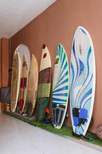 a row of surfboards lined up against a wall at KYO Surf Hostel in Las Palmas de Gran Canaria