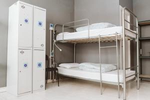 a bunk room with two bunk beds and lockers at KYO Surf Hostel in Las Palmas de Gran Canaria