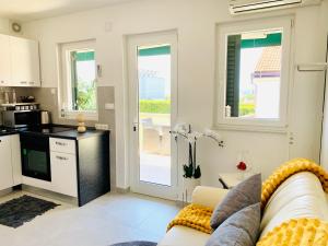 a living room with a couch and a kitchen at Villa EVAMAR, Island Krk Punat in Punat