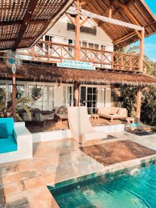 a villa with a swimming pool and a resort at Serenity Luxurious Beachfront Villa & Spa with private Infinity Pool, 8 Guests in Gili Air