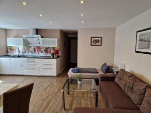 a living room with a couch and a table at Ferienwohnung Alte Linde in Hardheim