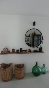 a mirror on a wall with baskets and vases at Sotto La Vigna Charm Stay Adults only vacation Suite in Montegrosso dʼAsti +61 photos