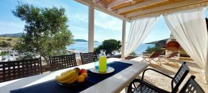 a table with a plate of fruit on top of it at Seaside cottage 'Little white port' in Lučica