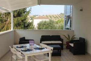 a balcony with a table and chairs and a large window at Il Pozzo in San Benedetto del Tronto