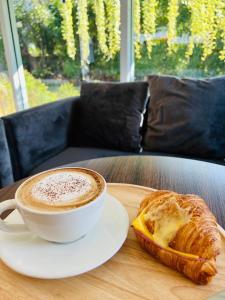 a cup of coffee and a pastry on a table at Preme village in Ubon Ratchathani