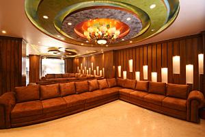 a living room with a large couch and a chandelier at Hotel Thamel Park in Kathmandu