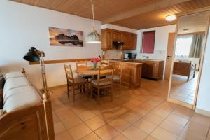 a kitchen and dining room with a table and chairs at Apartment Panorama Gerlitzen in Treffen