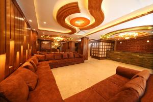 a large living room with brown couches and a ceiling at Hotel Thamel Park in Kathmandu