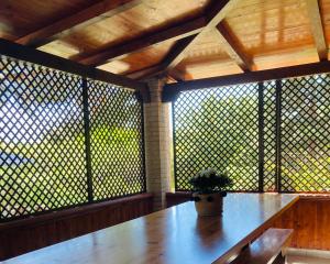a potted plant sitting on a table in a room with windows at Villa Lidia per una vacanza di relax in Solanas