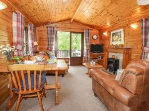 ein Wohnzimmer mit einem Sofa und einem Tisch in der Unterkunft Robin's Nest in Keswick