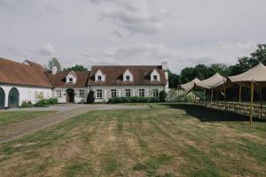 a large white house with tents in front of it at Villa Parkbos in De Pinte