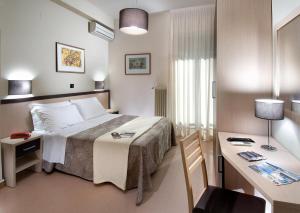 Postel nebo postele na pokoji v ubytování Hotel Conchiglia