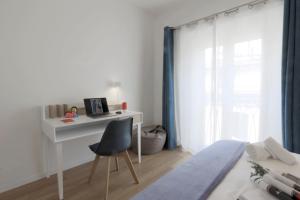 a white desk with a chair in a bedroom at Il Cortile di Milano in Milan