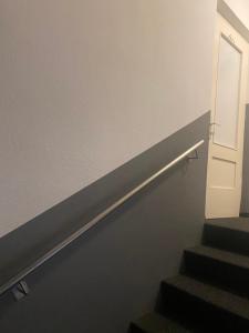 a stairway with a door and a stair railing at Hostel Villa Viva in Bregenz