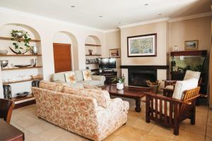 a living room with a couch and a fireplace at Mitre's Edge Pool House in Klapmuts