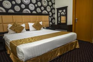 a bedroom with a large bed in a room at Quiet Rooms 1 Serviced Apartments in Riyadh +51 photos