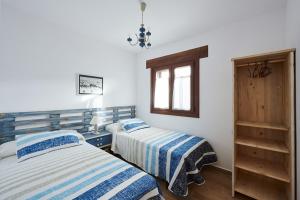 En eller flere senge i et værelse på Casa A'Pajera