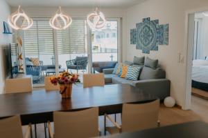a living room with a table and a couch at Luxury Apartment Weisses Rössl Residenzen in Pörtschach am Wörthersee